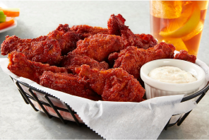 Hot wings on a basket with a side of ranch