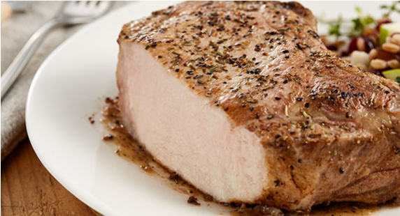 Seasoned pork steak on a white plate 