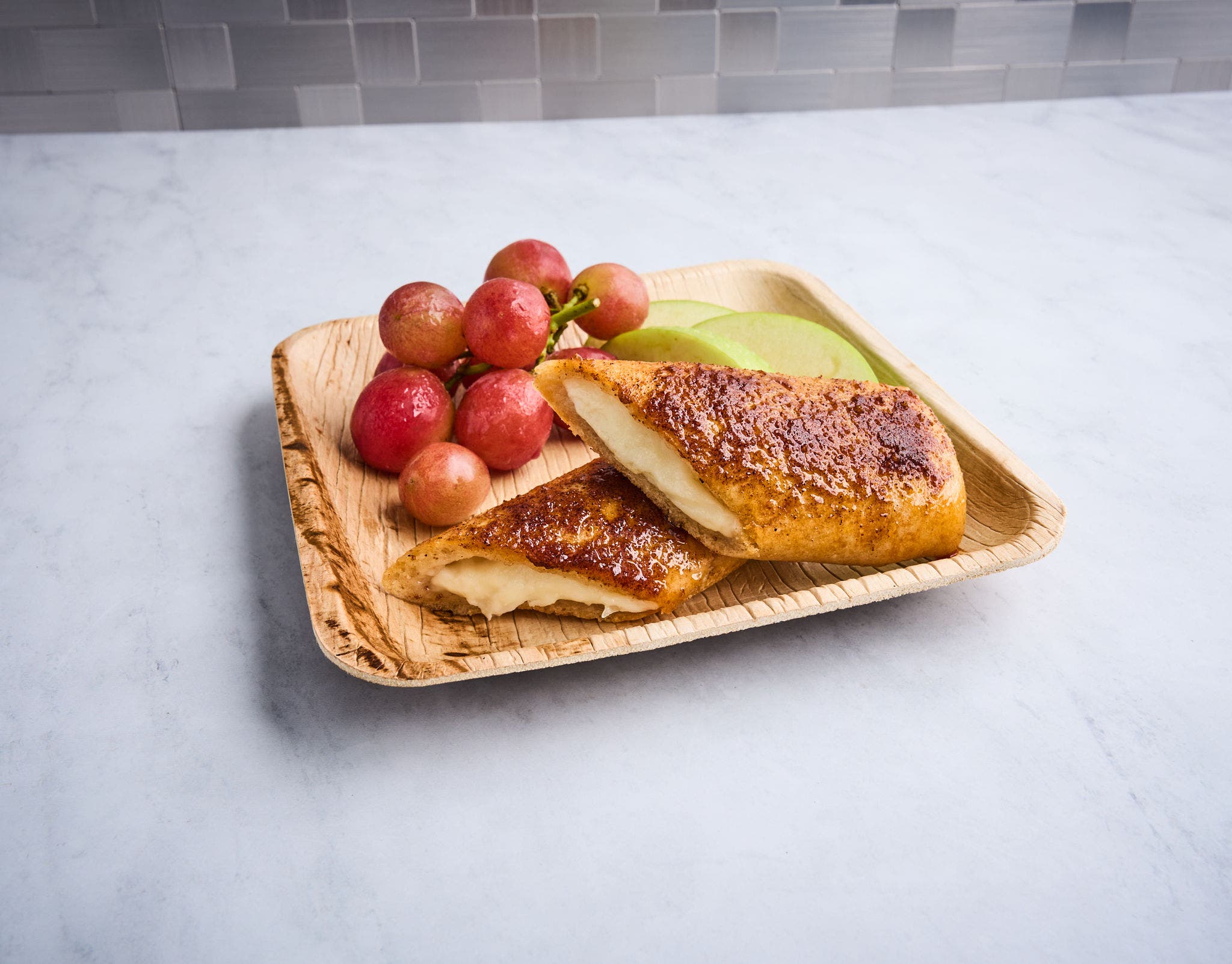 Chipotle Cinnamon Cheese Stuffed Bread on a plate with a side of grapes.