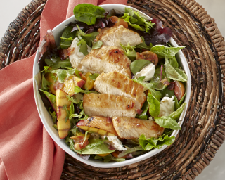 Appealing image of Tyson Red Label® Precision Cooked™ All Natural* Sous Vide Chicken Breast Filets served on a fresh salad.