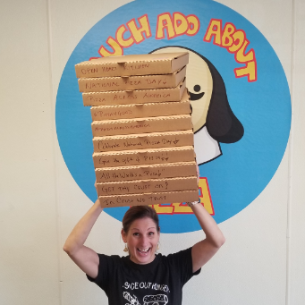 Smiling woman holding a stack of pizza boxes