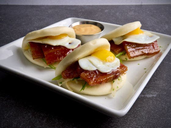 Three Bao Buns Benedict on a White Plate