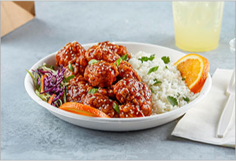 Asian rice bowl with teriyaki breaded chicken, oranges and slaw on the side 