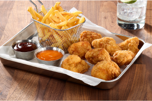 Bloness wings with a basket of fries and dipping sauces
