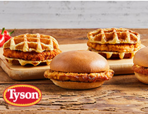 Three unpackaged chicken sandwiches plated on a wooden board