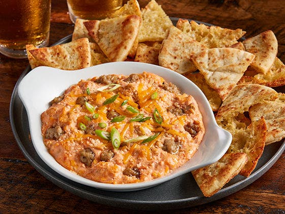 Pimento cheese and sausage dip plate with pita bread Image