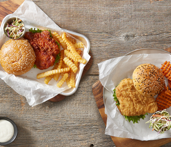 Chicken Sandwich on a Bun with Sides Presented in a Serving Basket