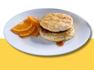 Chicken biscuit breakfast sandwich with chipotle strawberry and a side of orange slices