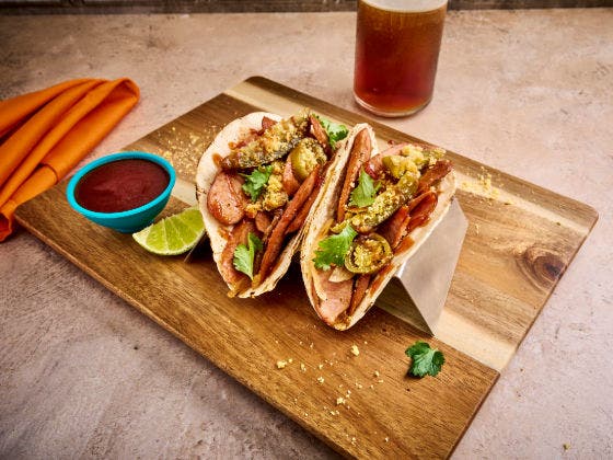 Texas BBQ Smoked Sausage Tacos on a cutting board.