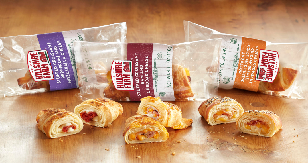 Six Hillshire Farm stuffed croissants, three open and three in the clear package 