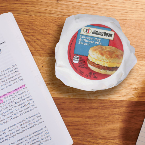 Breakfast packaged sandwich with a school paper