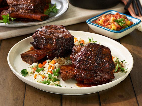 Image of Braised Mole Short Ribs on a Plate with some rice.