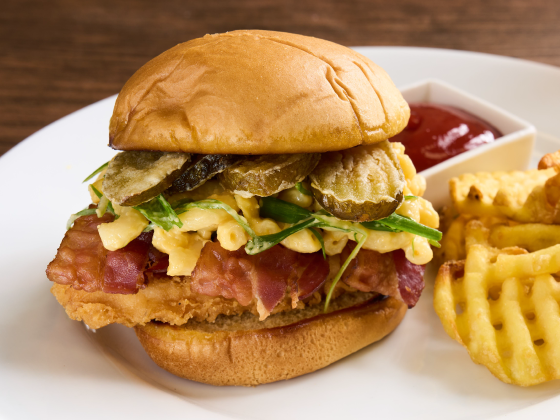 Crispy Chicken Bacon Swicy Ranch Sandwich on a plate with fries.