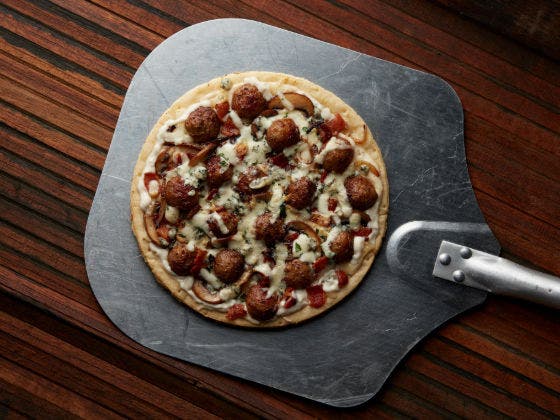 Bonici® Fully Cooked Oven Roasted Italian Style Pork and Beef Meatballs, .5 oz with shredded mozzarella and caramelized onions, sliced mushrooms and parsley. 