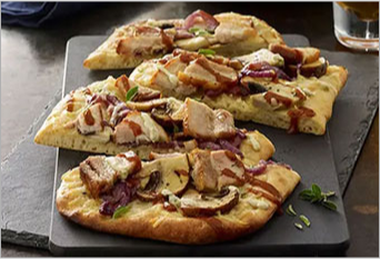 Tapas flatbread with pork belly, mushrooms and drizzled sauce